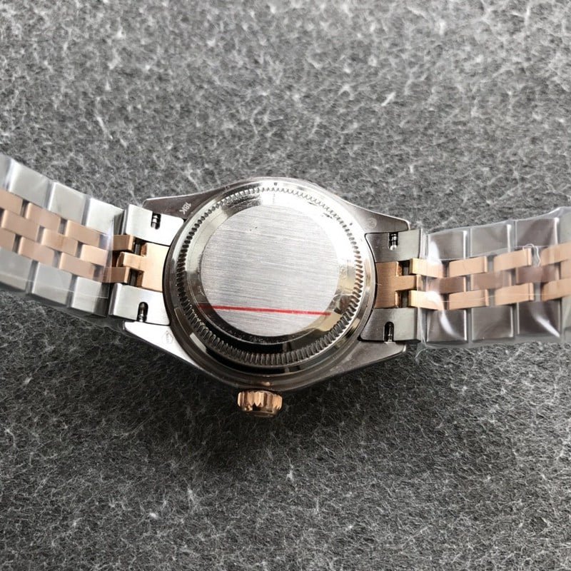 Replica Rolex Datejust watch, ladies' 28mm mechanical watch with a fluted bezel, rose gold and silver dial, and case back.