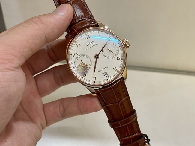 top-tier replica watch IWC men's white dial brown belt Portuguese 7 series natural diamond automatic movementleather strap watch front view